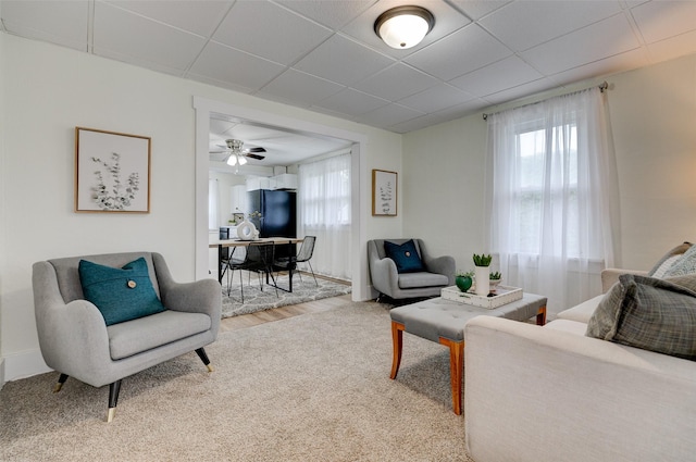 2403 E 14th St, Des Moines, IA 50316 - carpeted living room with a ceiling fan and a paneled ceiling