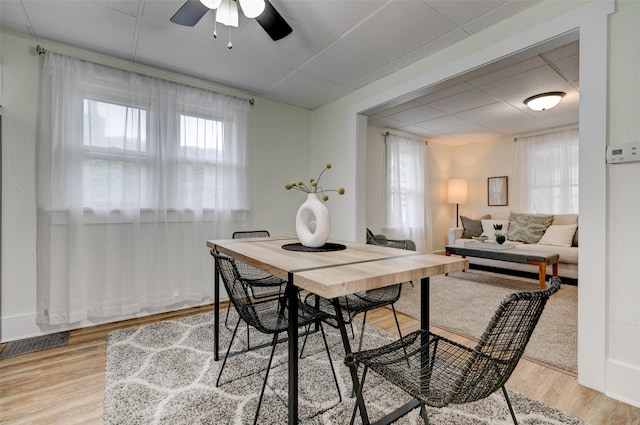 2403 E 14th St, Des Moines, IA 50316 - dining area with a paneled ceiling, light wood-style flooring, and a ceiling fan