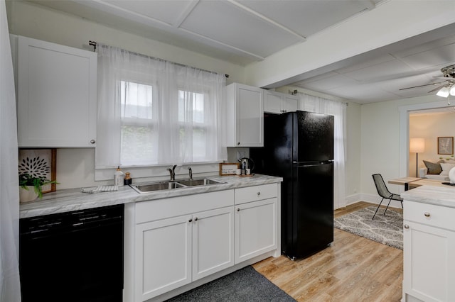 2403 E 14th St, Des Moines, IA 50316 - kitchen featuring a sink, black appliances, light wood-type flooring, white cabinetry, and a ceiling fan