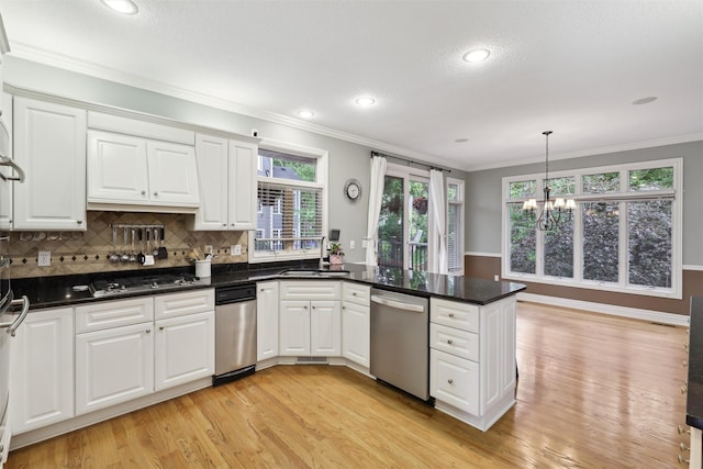 6909 Capitol View Ct, Johnston, IA 50131 - kitchen with stainless steel appliances, a sink, a chandelier, light wood-style floors, and a peninsula