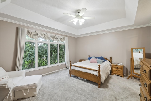 6909 Capitol View Ct, Johnston, IA 50131 - bedroom with a tray ceiling, light colored carpet, ceiling fan, crown molding, and baseboards