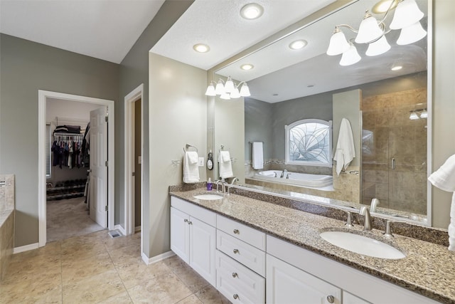 6909 Capitol View Ct, Johnston, IA 50131 - bathroom featuring a bath, a shower stall, double vanity, and a chandelier
