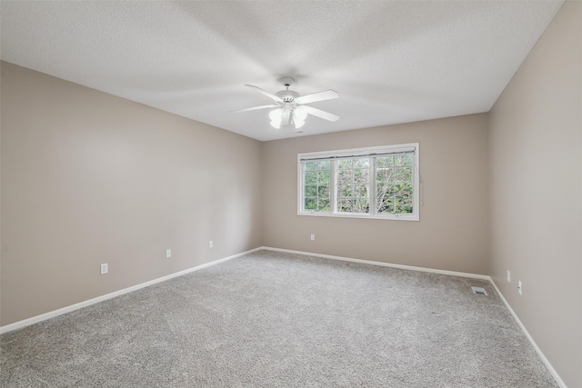 6909 Capitol View Ct, Johnston, IA 50131 - unfurnished room featuring carpet, ceiling fan, baseboards, and a textured ceiling