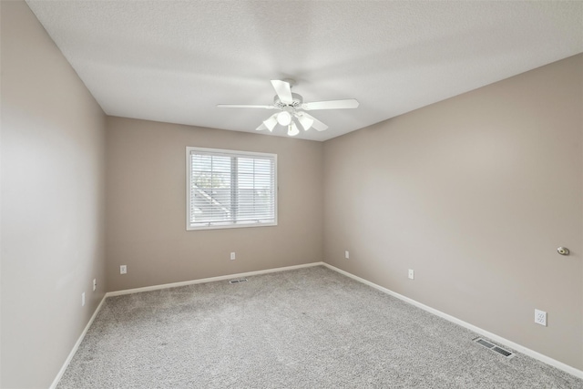 6909 Capitol View Ct, Johnston, IA 50131 - spare room featuring carpet floors, a ceiling fan, baseboards, and a textured ceiling