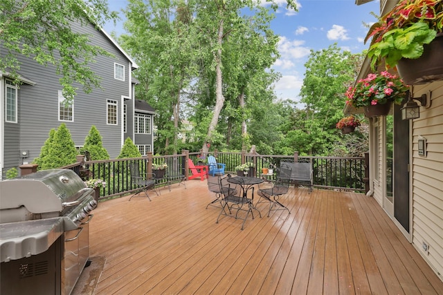 6909 Capitol View Ct, Johnston, IA 50131 - wooden terrace featuring outdoor dining space, area for grilling, and view of scattered trees