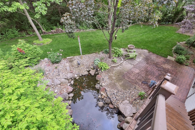 6909 Capitol View Ct, Johnston, IA 50131 - view of grassy yard featuring a garden pond and a patio