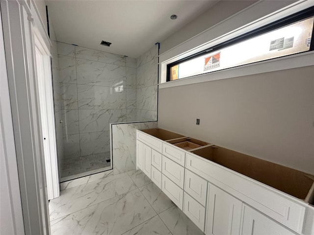 1405 NW Bull Run Ct, Waukee, IA 50263 - bathroom featuring marble look tile flooring and a marble finish shower