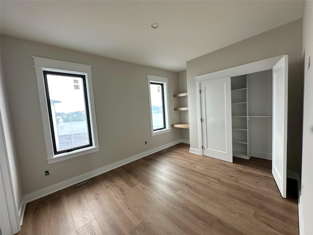 1405 NW Bull Run Ct, Waukee, IA 50263 - unfurnished bedroom with wood finished floors and a closet