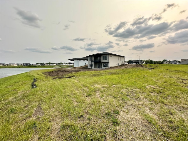 1405 NW Bull Run Ct, Waukee, IA 50263 - view of grassy yard with a carport and a water view