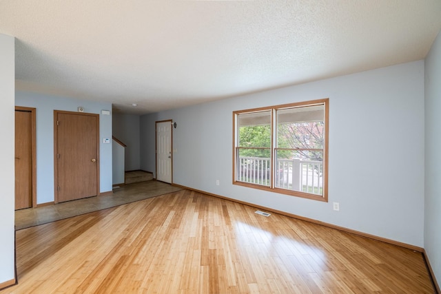 1540 8th St, Des Moines, IA 50314 - spare room with wood finished floors and stairway
