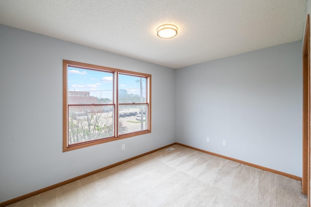 1540 8th St, Des Moines, IA 50314 - empty room with light carpet and a textured ceiling
