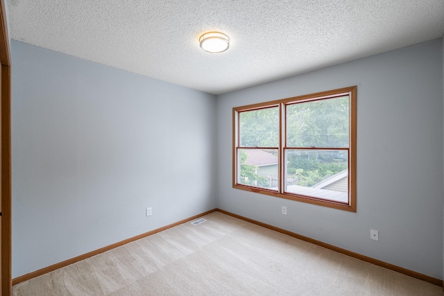 1540 8th St, Des Moines, IA 50314 - empty room featuring light carpet and a textured ceiling