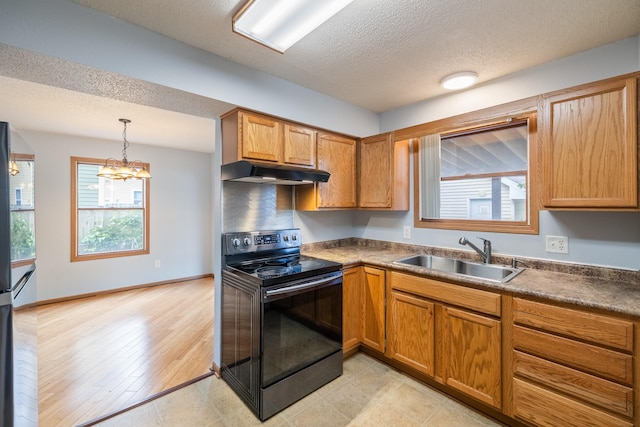1540 8th St, Des Moines, IA 50314 - kitchen with black electric range, under cabinet range hood, a chandelier, dark countertops, and a textured ceiling