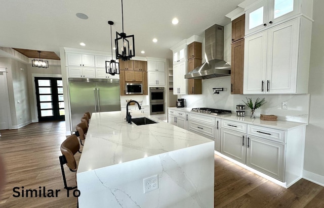 1410 NW Bull Run Ct, Waukee, IA 50263 - kitchen featuring a sink, wall chimney exhaust hood, appliances with stainless steel finishes, recessed lighting, and dark wood finished floors