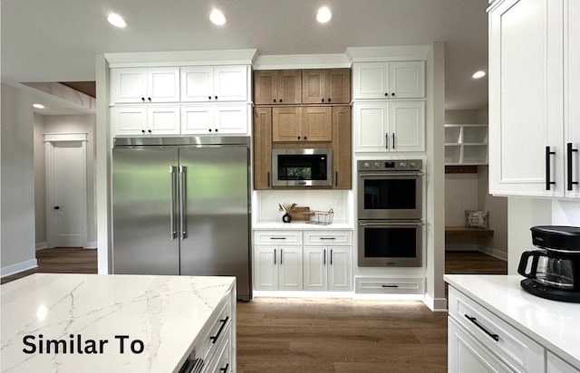 1410 NW Bull Run Ct, Waukee, IA 50263 - kitchen with built in appliances, white cabinets, dark wood-style floors, and recessed lighting