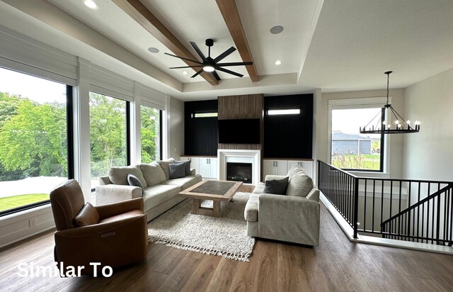 1410 NW Bull Run Ct, Waukee, IA 50263 - living room featuring a chandelier, wood finished floors, ceiling fan, a glass covered fireplace, and recessed lighting