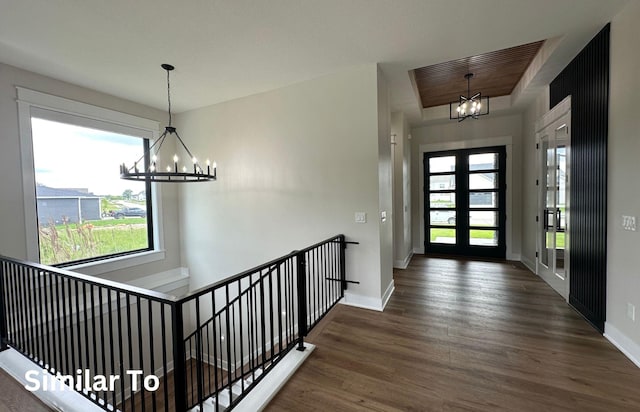 1410 NW Bull Run Ct, Waukee, IA 50263 - entryway with a chandelier, wood finished floors, plenty of natural light, and baseboards
