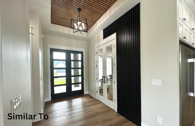 1410 NW Bull Run Ct, Waukee, IA 50263 - foyer featuring french doors, wood finished floors, baseboards, a chandelier, and wooden ceiling