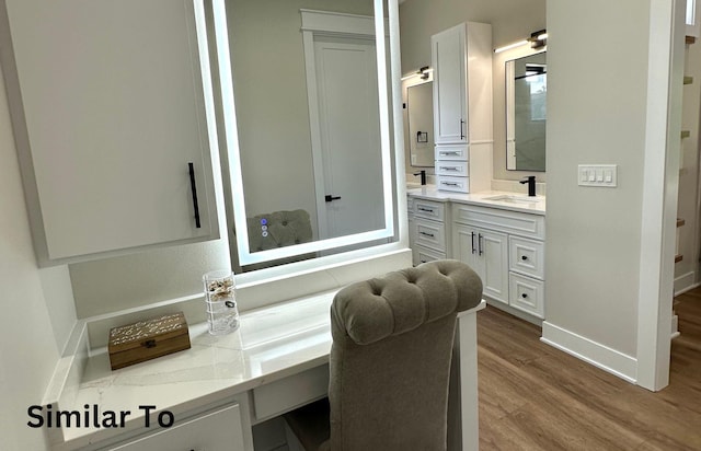 1410 NW Bull Run Ct, Waukee, IA 50263 - bathroom featuring wood finished floors, baseboards, and vanity