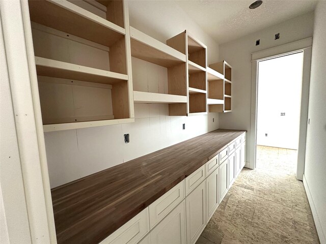 1410 NW Bull Run Ct, Waukee, IA 50263 - kitchen with butcher block counters and a textured ceiling