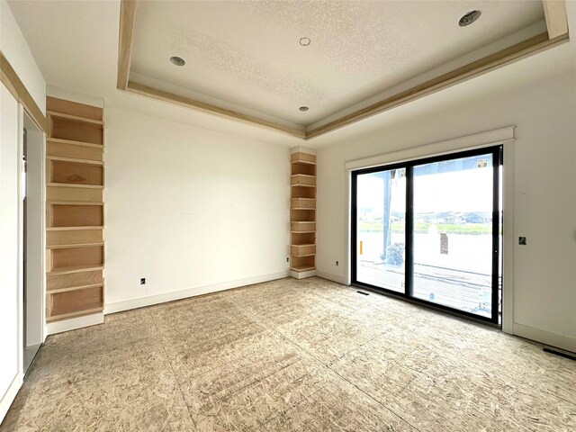 1410 NW Bull Run Ct, Waukee, IA 50263 - empty room with a tray ceiling, a textured ceiling, baseboards, and crown molding