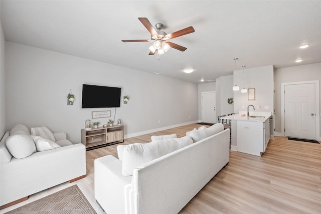 714 Umbra Pl, Norwalk, IA 50211 - living room with a ceiling fan, light wood-style flooring, recessed lighting, and baseboards