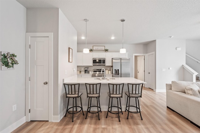 714 Umbra Pl, Norwalk, IA 50211 - kitchen featuring appliances with stainless steel finishes, a breakfast bar, a peninsula, white cabinetry, and recessed lighting