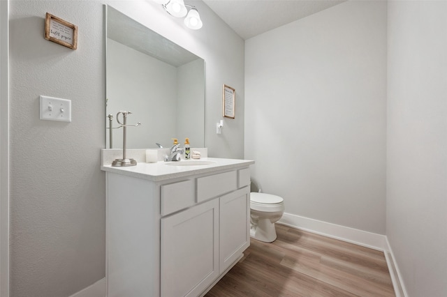 714 Umbra Pl, Norwalk, IA 50211 - half bath featuring wood finished floors, vanity, toilet, and baseboards
