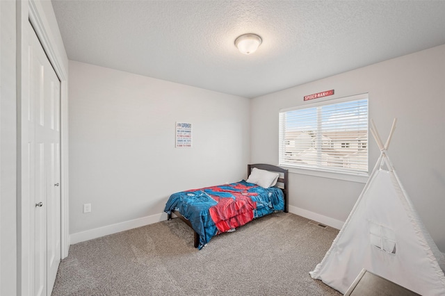 714 Umbra Pl, Norwalk, IA 50211 - carpeted bedroom featuring a textured ceiling, baseboards, and a closet