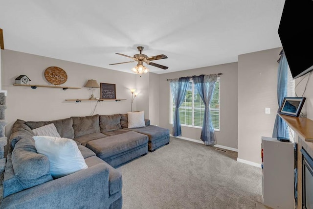 113 NW 27th St, Ankeny, IA 50023 - living room featuring baseboards, ceiling fan, and carpet