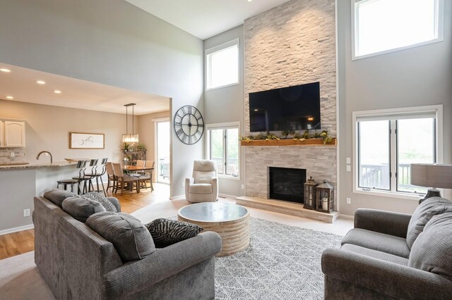 1625 S 50th Pl, West Des Moines, IA 50265 - living area featuring high vaulted ceiling, a fireplace, light wood-style flooring, and recessed lighting