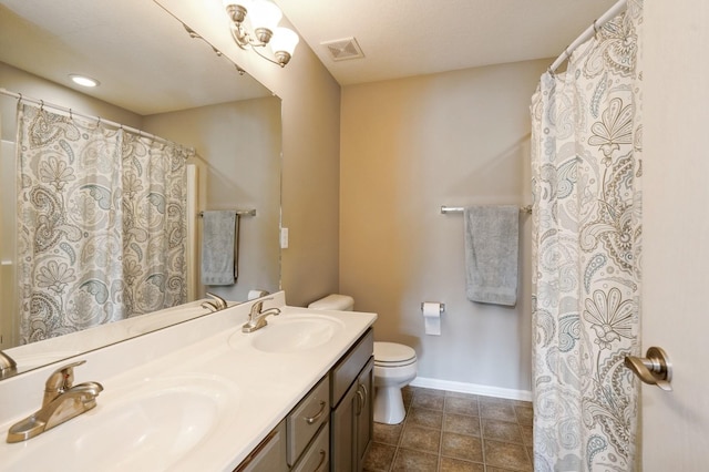 1625 S 50th Pl, West Des Moines, IA 50265 - full bathroom featuring baseboards, double vanity, toilet, tile patterned floors, and curtained shower