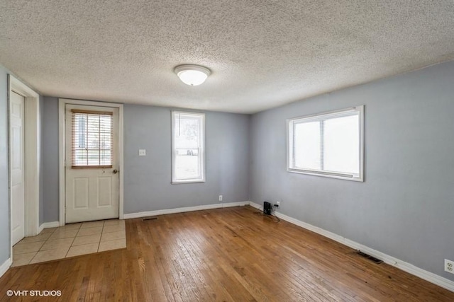 201 Main St, New Virginia, IA 50210 - entryway featuring hardwood / wood-style floors, baseboards, and a textured ceiling