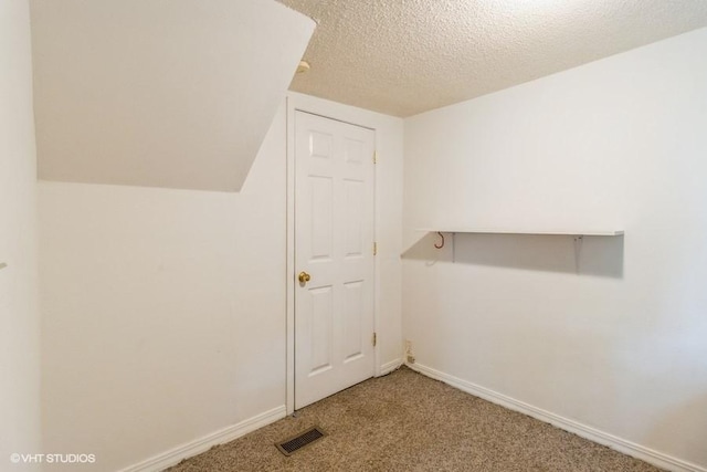 201 Main St, New Virginia, IA 50210 - additional living space with carpet floors, baseboards, and a textured ceiling