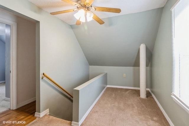 201 Main St, New Virginia, IA 50210 - hall featuring an upstairs landing, vaulted ceiling, carpet flooring, and baseboards