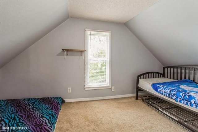 201 Main St, New Virginia, IA 50210 - bedroom featuring lofted ceiling, carpet floors, baseboards, and a textured ceiling