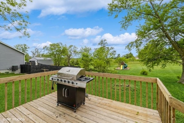 201 Main St, New Virginia, IA 50210 - wooden terrace featuring a playground, a grill, and a lawn