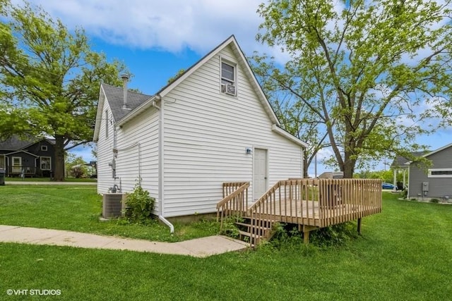 201 Main St, New Virginia, IA 50210 - rear view of property featuring a deck, a yard, and cooling unit