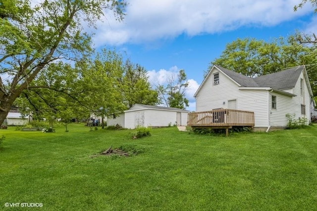 201 Main St, New Virginia, IA 50210 - view of grassy yard with a wooden deck and an outbuilding