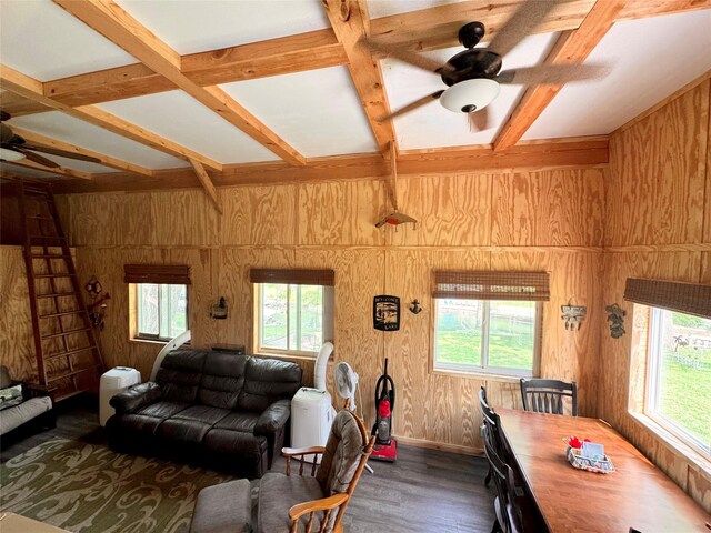3170 Morman Trl, Ellston, IA 50074 - living room featuring ceiling fan, healthy amount of natural light, wood walls, dark wood-type flooring, and coffered ceiling