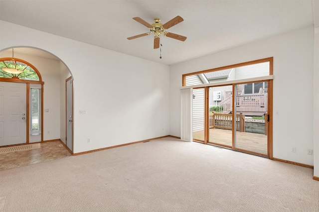 6799 NW 57th St, Johnston, IA 50131 - unfurnished room featuring arched walkways, light carpet, baseboards, and a ceiling fan