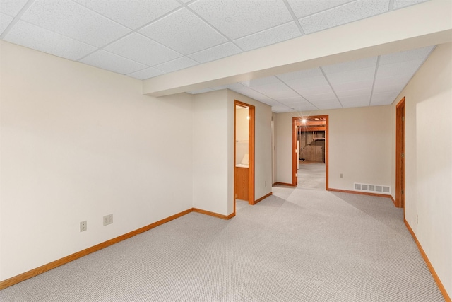 6799 NW 57th St, Johnston, IA 50131 - finished below grade area featuring light carpet, a paneled ceiling, and baseboards