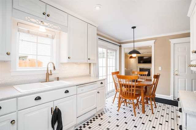 2403 Guenever Ct, Altoona, IA 50009 - kitchen with a sink, ornamental molding, white cabinetry, light countertops, and pendant lighting