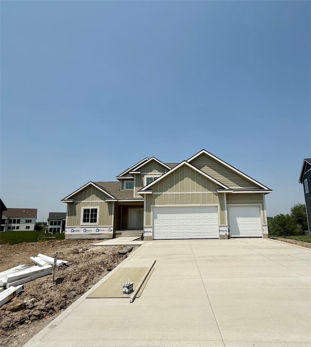 2313 Green Leaf Cir, Norwalk, IA 50211 - view of front of home featuring board and batten siding, driveway, and a garage