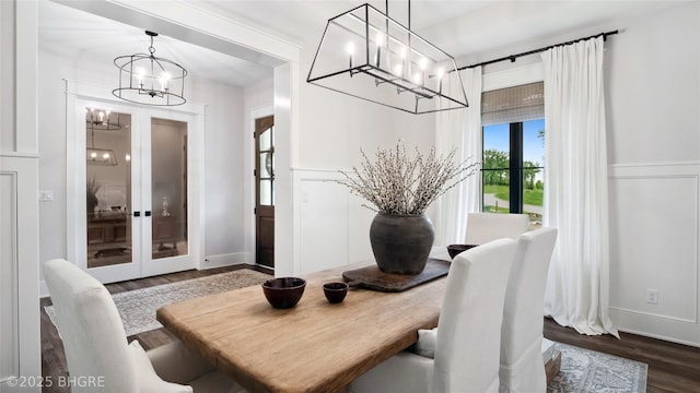 815 S Kingswood Ct, West Des Moines, IA 50266 - dining space featuring a chandelier, dark wood-style floors, and baseboards