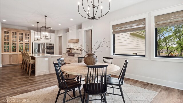 815 S Kingswood Ct, West Des Moines, IA 50266 - dining room with a chandelier, recessed lighting, wood finished floors, and baseboards