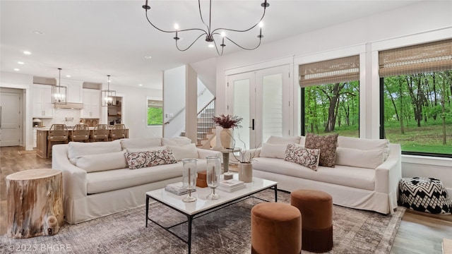 815 S Kingswood Ct, West Des Moines, IA 50266 - living room with light wood-style floors, stairs, a chandelier, and recessed lighting