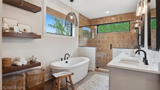 815 S Kingswood Ct, West Des Moines, IA 50266 - full bath with a stall shower, a soaking tub, double vanity, and recessed lighting