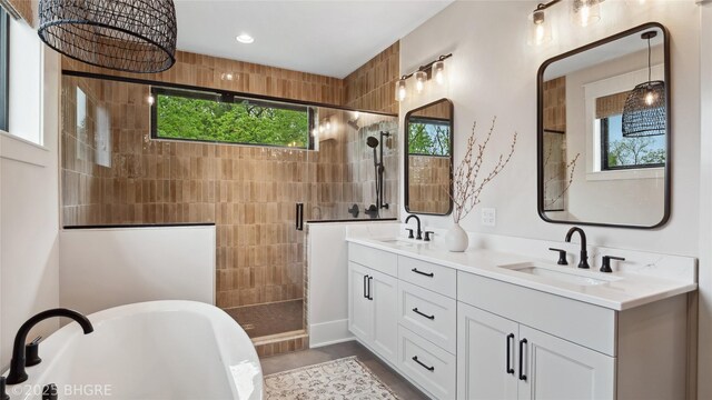 815 S Kingswood Ct, West Des Moines, IA 50266 - bathroom featuring a stall shower, double vanity, a soaking tub, and recessed lighting