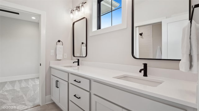 815 S Kingswood Ct, West Des Moines, IA 50266 - bathroom with double vanity and baseboards